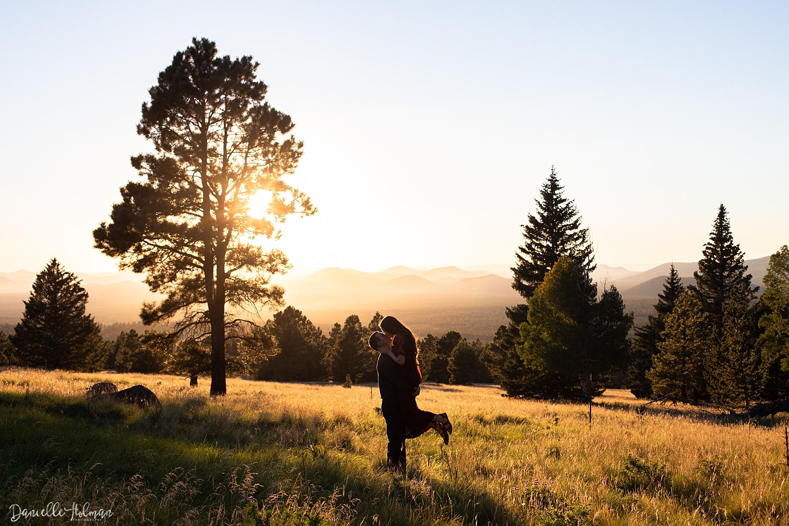 Couple kissing at sunset at Mt. Humphrey in Flagstaff by Danielle Holman Photography