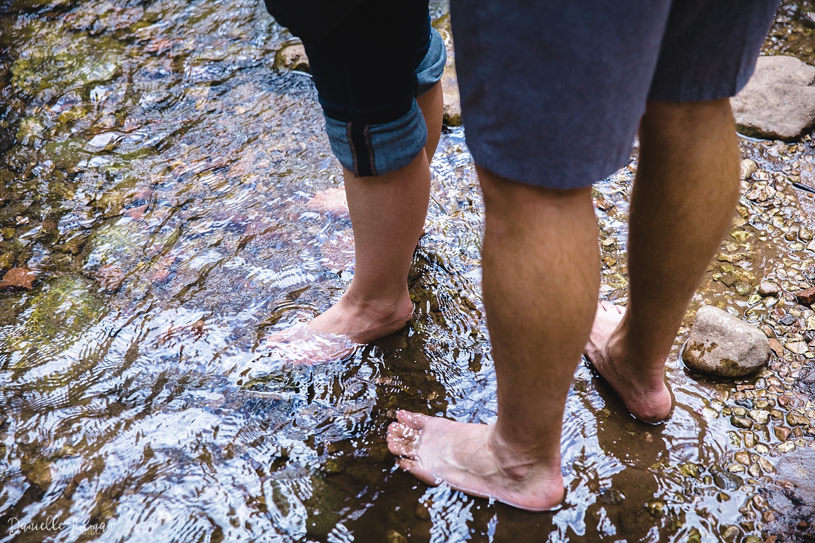 Feet in a creek, with rippling water