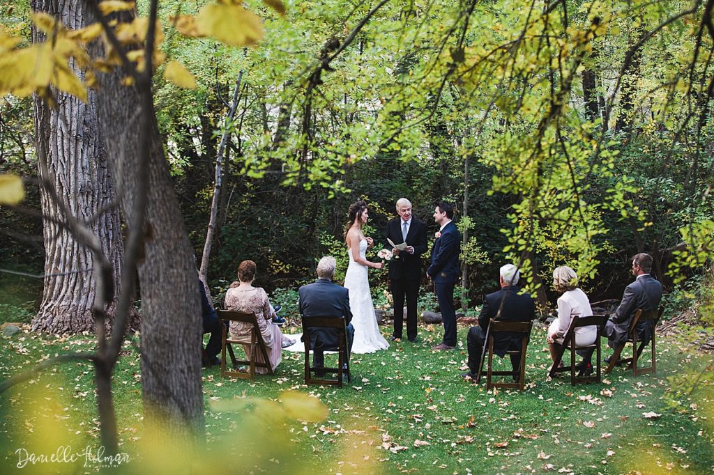 Fall foliage in the foreground of the wedding ceremony