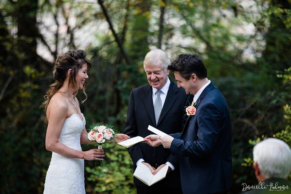 Groom hands bride her vows