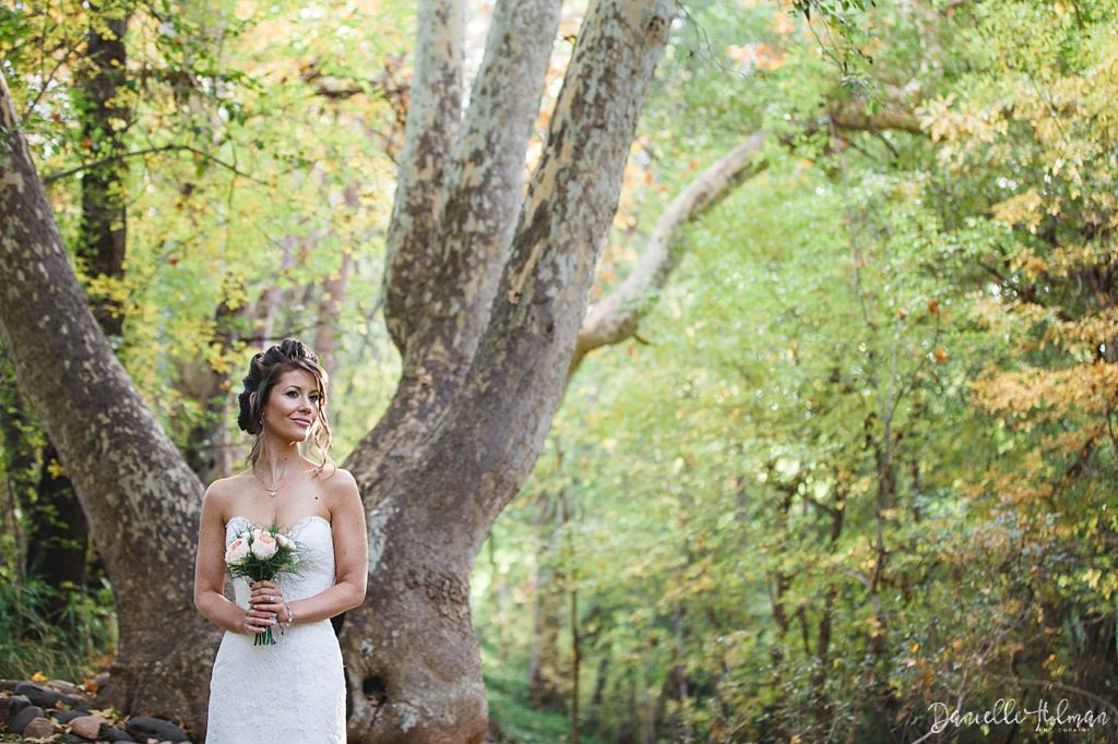 Beautiful bride portrait with fall foliage in the background